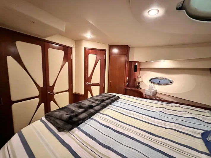 Hippeace Yacht Photos Pics Luxurious cabin interior of 2009 Silverton Ovation 52 yacht with striped bedding.