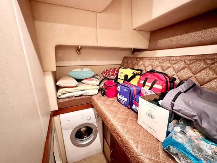 Hippeace Yacht Photos Pics Laundry area in 2009 Silverton Ovation 52 yacht with storage and washing machine.