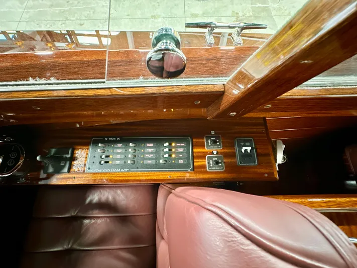 Luv N It Yacht Photos Pics Control panel of a 2015 Van Dam 35 boat with leather seating and wooden finish.