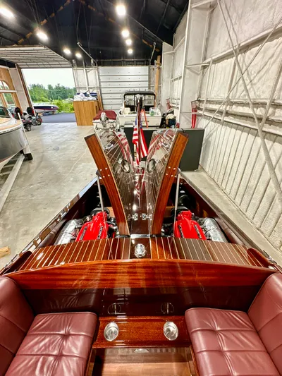 Luv N It Yacht Photos Pics Luxurious 2015 Van Dam 35 boat with polished wood interior and red leather seats in a spacious garage.