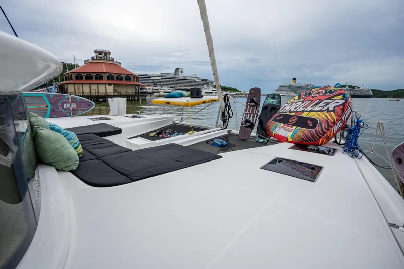  Yacht Photos Pics Lagoon 50 catamaran deck with water sports gear, docked near cruise ships, 2020 model.