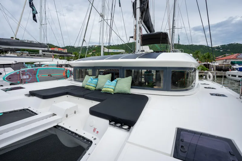  Yacht Photos Pics 2020 Lagoon 50 catamaran with cushioned deck seating, docked in a marina.