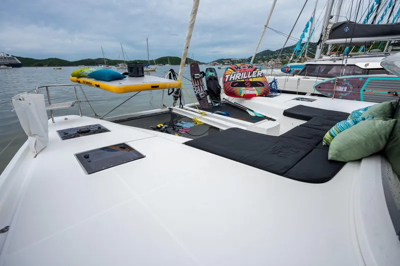  Yacht Photos Pics Luxurious 2020 Lagoon 50 catamaran deck with water sports equipment and scenic marina view.