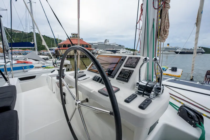 Yacht Photos Pics Helm of 2020 Lagoon 50 catamaran with navigation instruments in a marina setting.