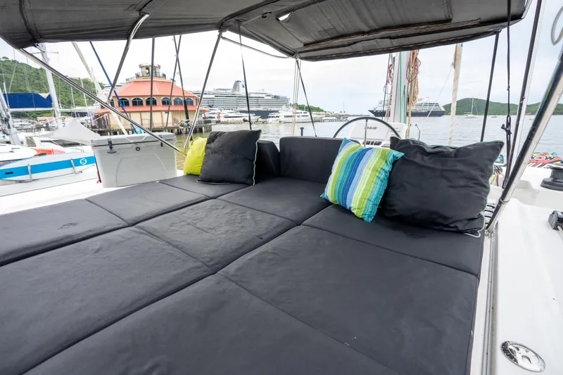  Yacht Photos Pics Luxurious Lagoon 50 catamaran deck with comfortable seating, colorful cushions, and marina view.