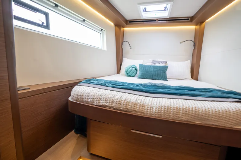  Yacht Photos Pics Luxurious cabin interior of 2020 Lagoon 50 yacht with cozy bedding and modern design.