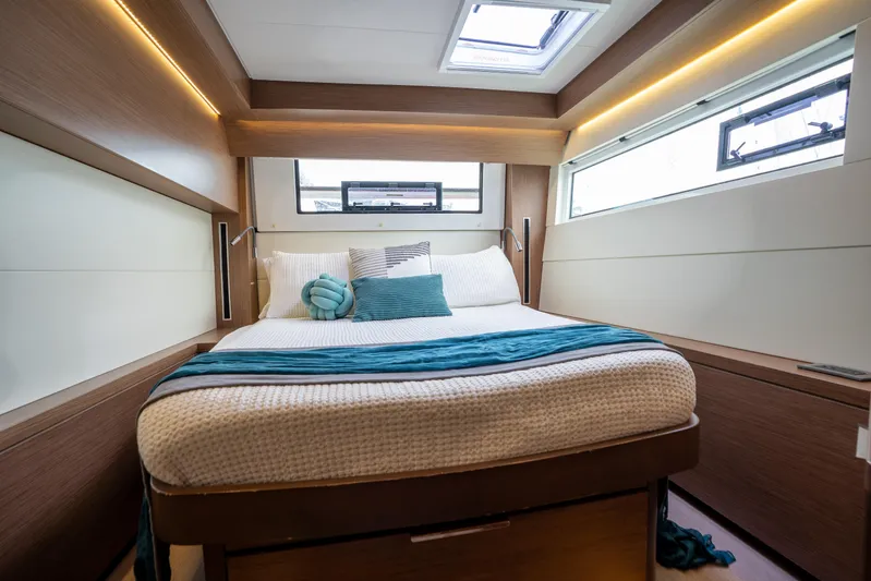  Yacht Photos Pics Luxurious cabin interior of 2020 Lagoon 50 yacht with cozy bedding and modern design.