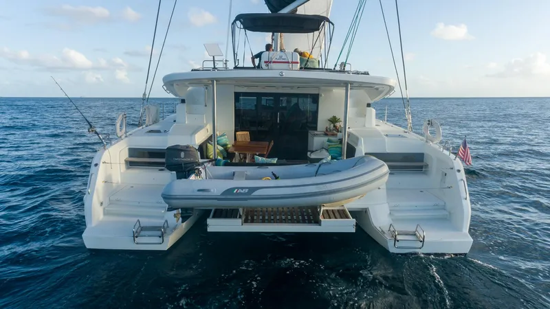  Yacht Photos Pics 2020 Lagoon 50 catamaran on open sea with inflatable boat.