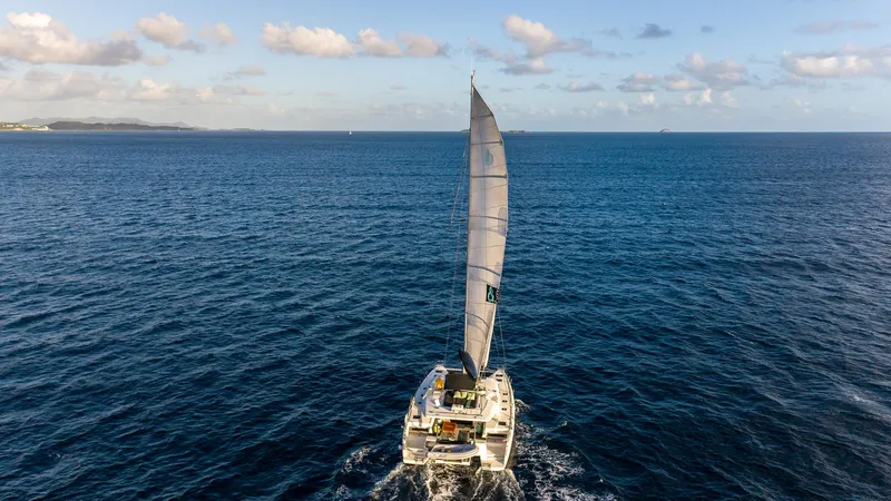  Yacht Photos Pics 2020 Lagoon 50 catamaran sailing on open ocean under clear blue sky.