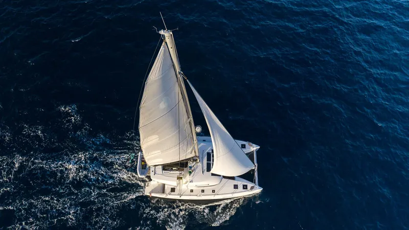  Yacht Photos Pics Aerial view of 2020 Lagoon 50 sailing yacht on open sea.