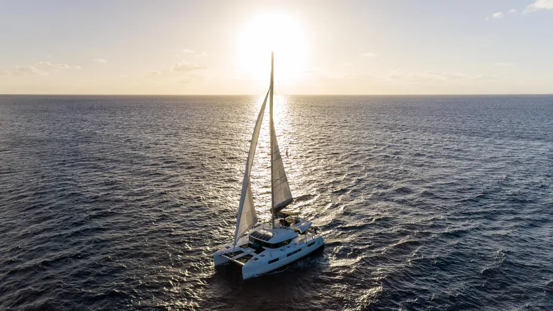  Yacht Photos Pics Lagoon 50 catamaran sailing at sunset on open sea, 2020 model.