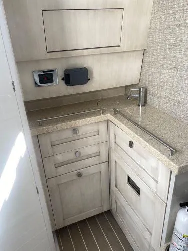 Relapse Yacht Photos Pics 2021 HCB 42 Lujo boat interior with modern kitchenette and storage cabinets.