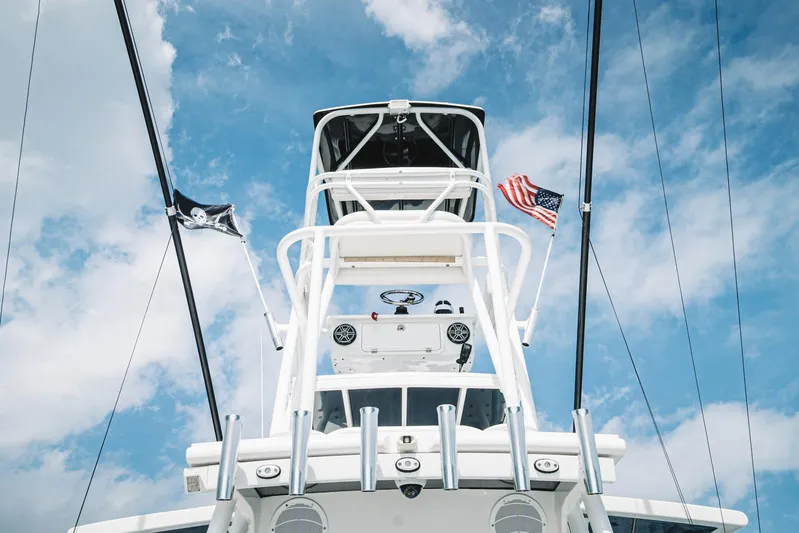 Relapse Yacht Photos Pics 2021 HCB 42 Lujo boat tower with flags against a blue sky.