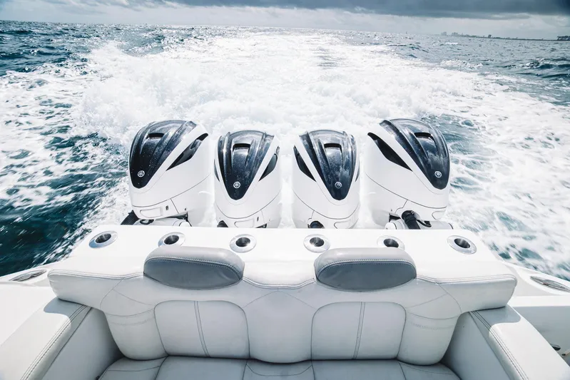 Relapse Yacht Photos Pics 2021 HCB 42 Lujo boat with four powerful outboard engines cruising on open water.