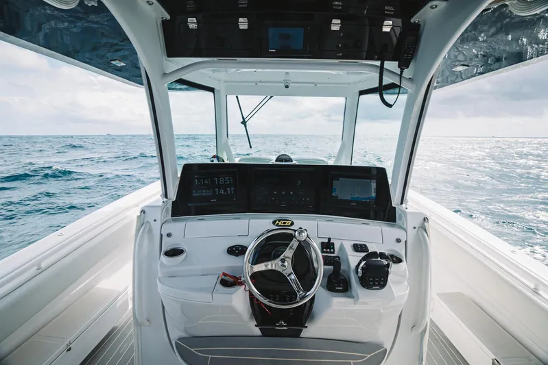 Relapse Yacht Photos Pics 2021 HCB 42 Lujo boat cockpit with ocean view, featuring modern navigation equipment.