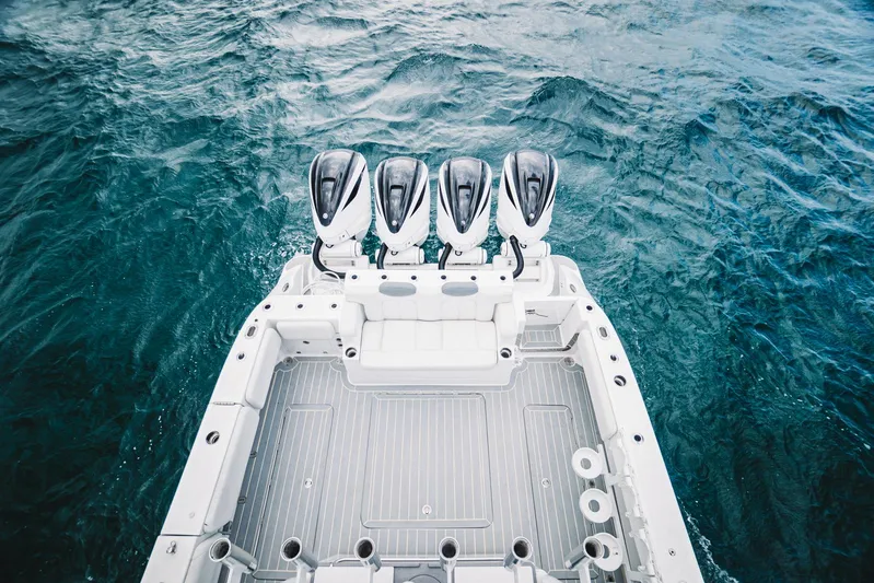 Relapse Yacht Photos Pics 2021 HCB 42 Lujo boat with four powerful outboard engines on open water.