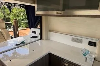  Yacht Photos Pics 2021 Regal 38 XO yacht interior with modern kitchen and sleek countertops.