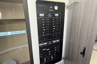 Yacht Photos Pics 2021 Regal 38 XO electrical panel inside cabin, showcasing control switches and gauges.