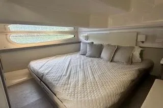  Yacht Photos Pics Luxurious bedroom interior of 2021 Regal 38 XO yacht with elegant bedding.