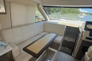  Yacht Photos Pics Interior of 2021 Regal 38 XO yacht with white seating and scenic window view.