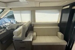  Yacht Photos Pics 2021 Regal 38 XO yacht interior with beige seating and modern helm.