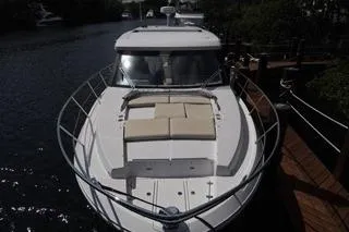  Yacht Photos Pics 2021 Regal 38 XO yacht docked on a serene waterway.