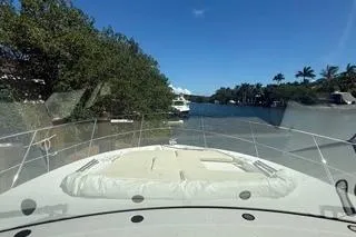  Yacht Photos Pics 2021 Regal 38 XO yacht cruising through a scenic waterway with lush greenery.