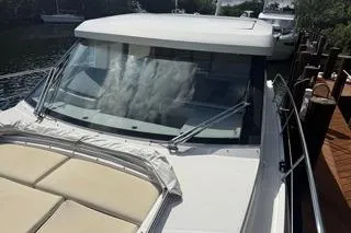  Yacht Photos Pics 2021 Regal 38 XO yacht docked, featuring sleek design and spacious deck.