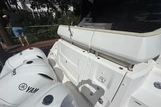  Yacht Photos Pics 2021 Regal 38 XO boat with Yamaha outboard engines, docked near greenery.