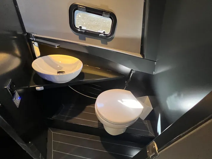 G10 Yacht Photos Pics Compact bathroom in 2024 G-Force 10 with modern sink and toilet.