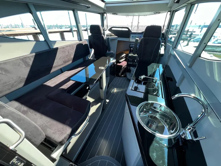 G10 Yacht Photos Pics 2024 G-Force 10 boat interior with seating, table, and kitchenette.