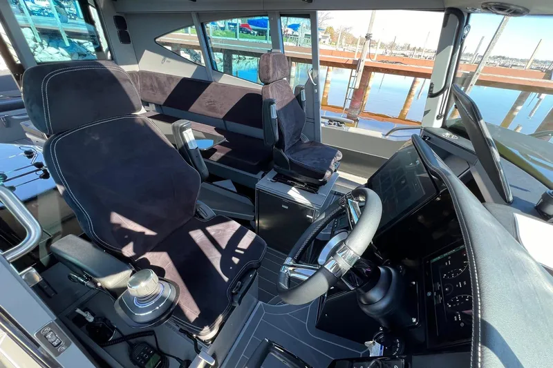 G10 Yacht Photos Pics 2024 G-Force 10 boat interior with modern steering and seating, dockside view.