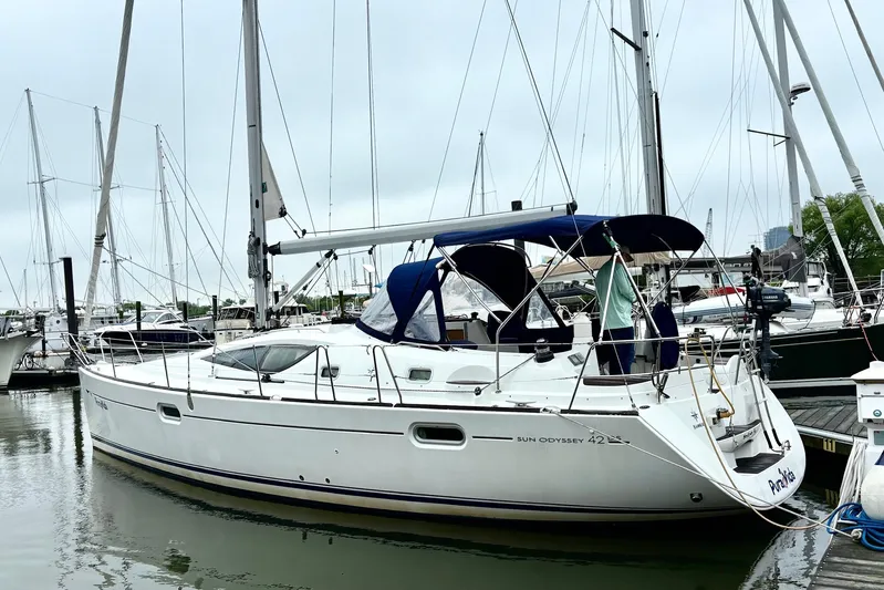 Pura Vida Yacht Photos Pics 2007 Jeanneau Sun Odyssey 42 DS sailboat docked in a marina, featuring a sleek design.