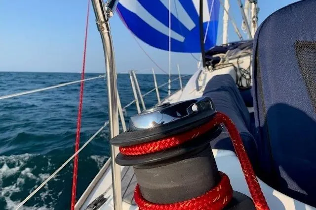 Pura Vida Yacht Photos Pics 2007 Jeanneau Sun Odyssey 42 DS sailboat with red rope on winch, sailing on open sea.