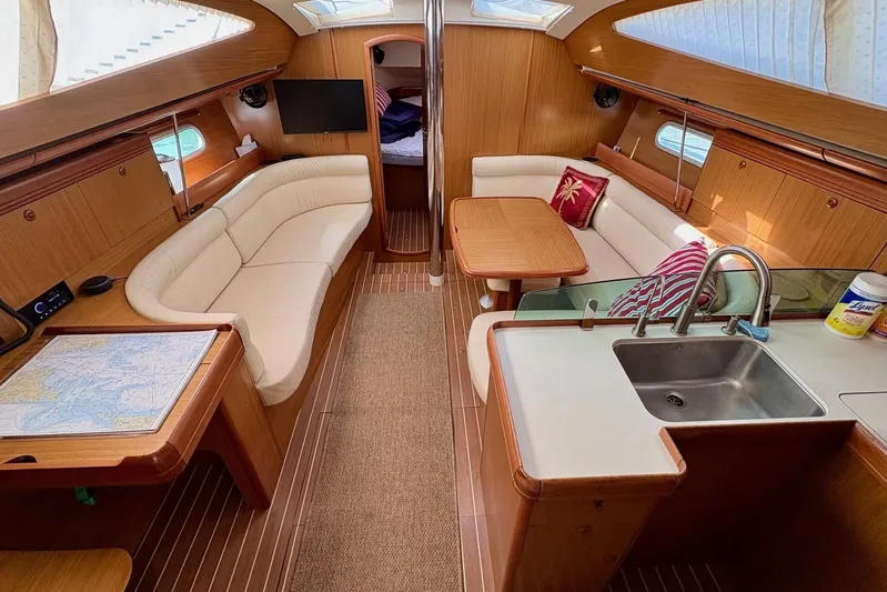 Pura Vida Yacht Photos Pics Interior of 2007 Jeanneau Sun Odyssey 42 DS yacht with elegant seating and kitchen area.