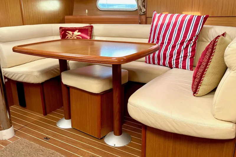 Pura Vida Yacht Photos Pics Interior of 2007 Jeanneau Sun Odyssey 42 DS with cozy seating and decorative pillows.