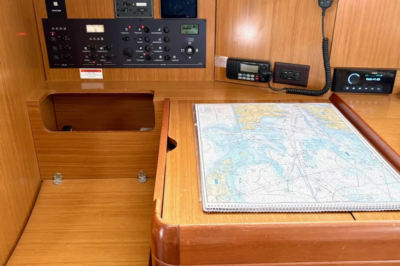 Pura Vida Yacht Photos Pics Navigation station of 2007 Jeanneau Sun Odyssey 42 DS with map and control panel.