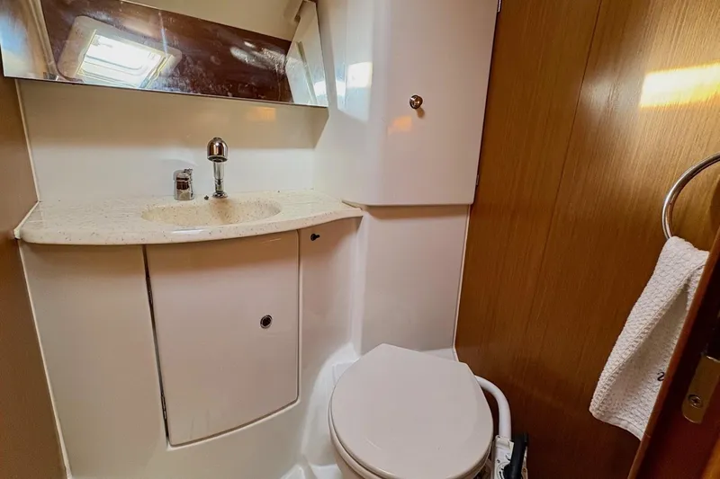 Pura Vida Yacht Photos Pics 2007 Jeanneau Sun Odyssey 42 DS yacht bathroom with sink, mirror, and toilet.