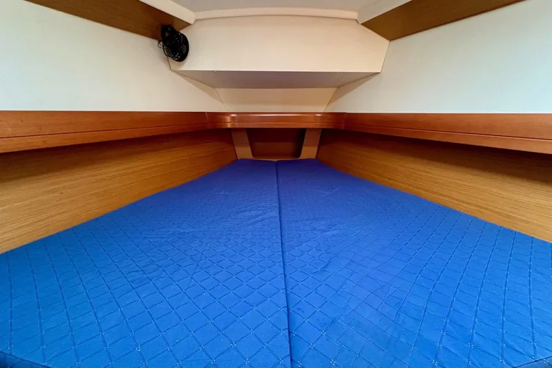 Pura Vida Yacht Photos Pics 2007 Jeanneau Sun Odyssey 42 DS cabin with blue bedding and wooden interior.