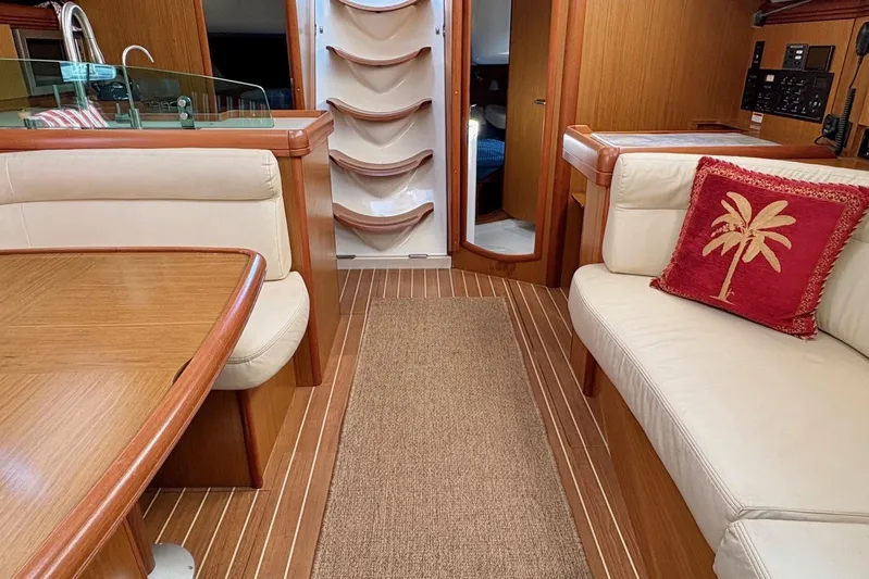 Pura Vida Yacht Photos Pics Luxurious interior of 2007 Jeanneau Sun Odyssey 42 DS sailboat with elegant wood finish.