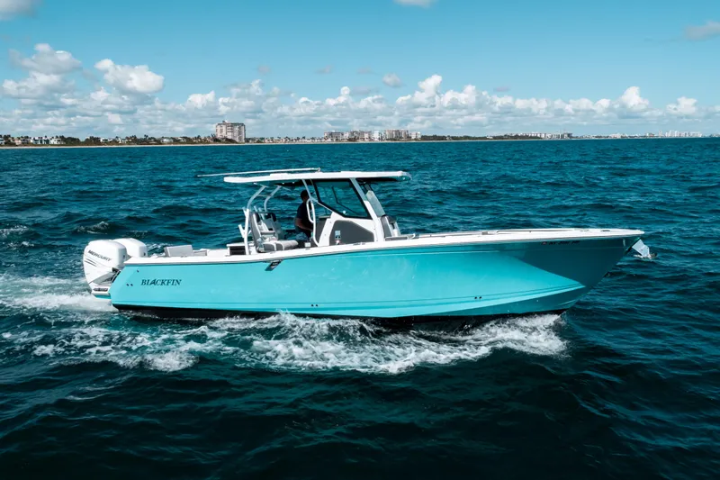  Yacht Photos Pics 2020 Blackfin 332 CC boat cruising on open blue ocean under clear sky.