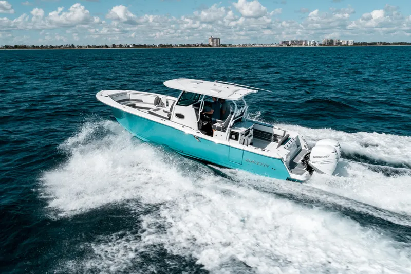  Yacht Photos Pics 2020 Blackfin 332 CC boat cruising on open ocean with clear skies.