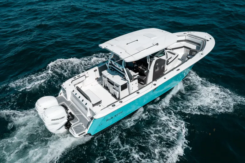  Yacht Photos Pics 2020 Blackfin 332 CC boat cruising on open water, featuring twin Mercury engines.