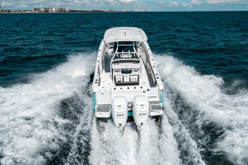  Yacht Photos Pics 2020 Blackfin 332 CC boat cruising on open ocean waters.