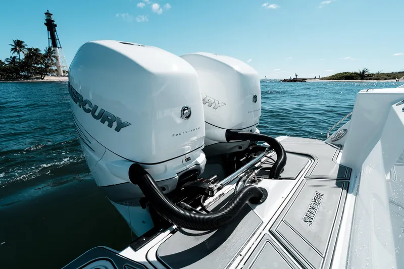  Yacht Photos Pics 2020 Blackfin 332 CC boat with twin Mercury engines near a lighthouse.