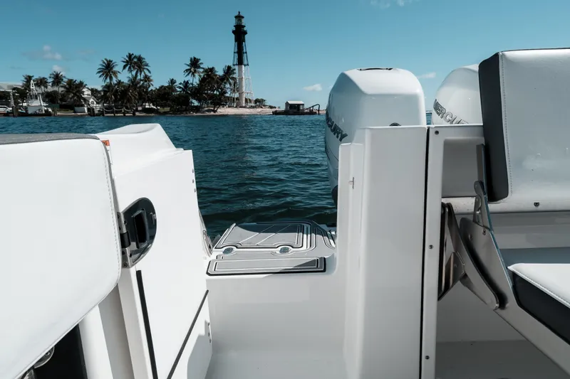  Yacht Photos Pics 2020 Blackfin 332 CC boat with lighthouse and palm trees in the background.
