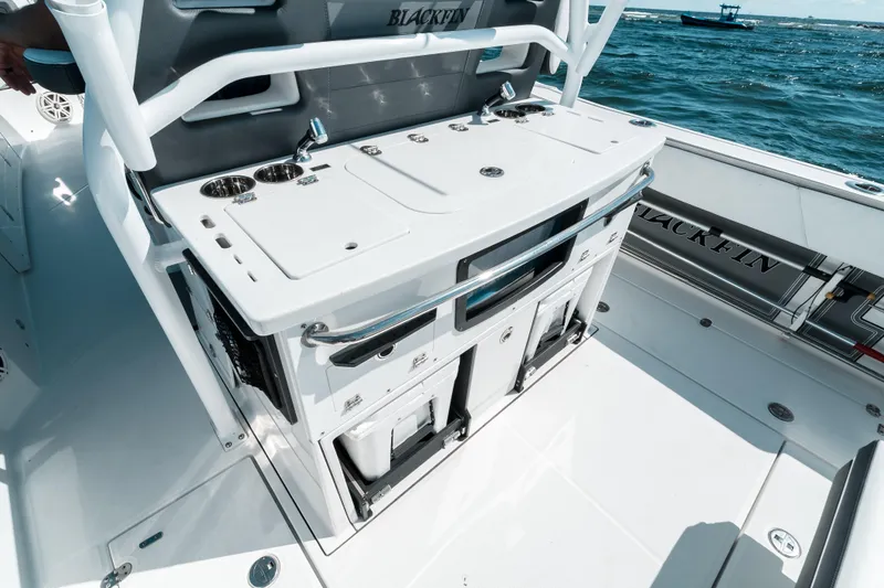 Yacht Photos Pics 2020 Blackfin 332 CC boat interior with storage and seating, on open water.