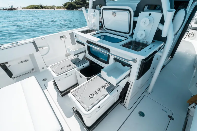  Yacht Photos Pics 2020 Blackfin 332 CC boat interior with storage and sink, docked by the water.