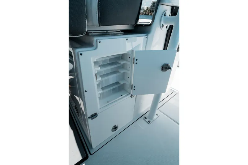  Yacht Photos Pics 2020 Blackfin 332 CC boat storage compartment with open door and organized shelves.