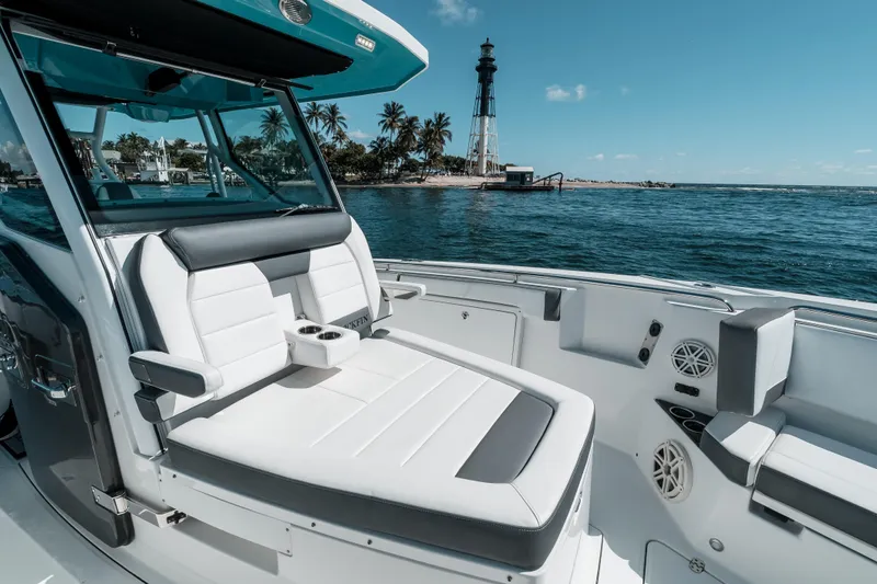  Yacht Photos Pics 2020 Blackfin 332 CC boat interior with ocean view and lighthouse in background.